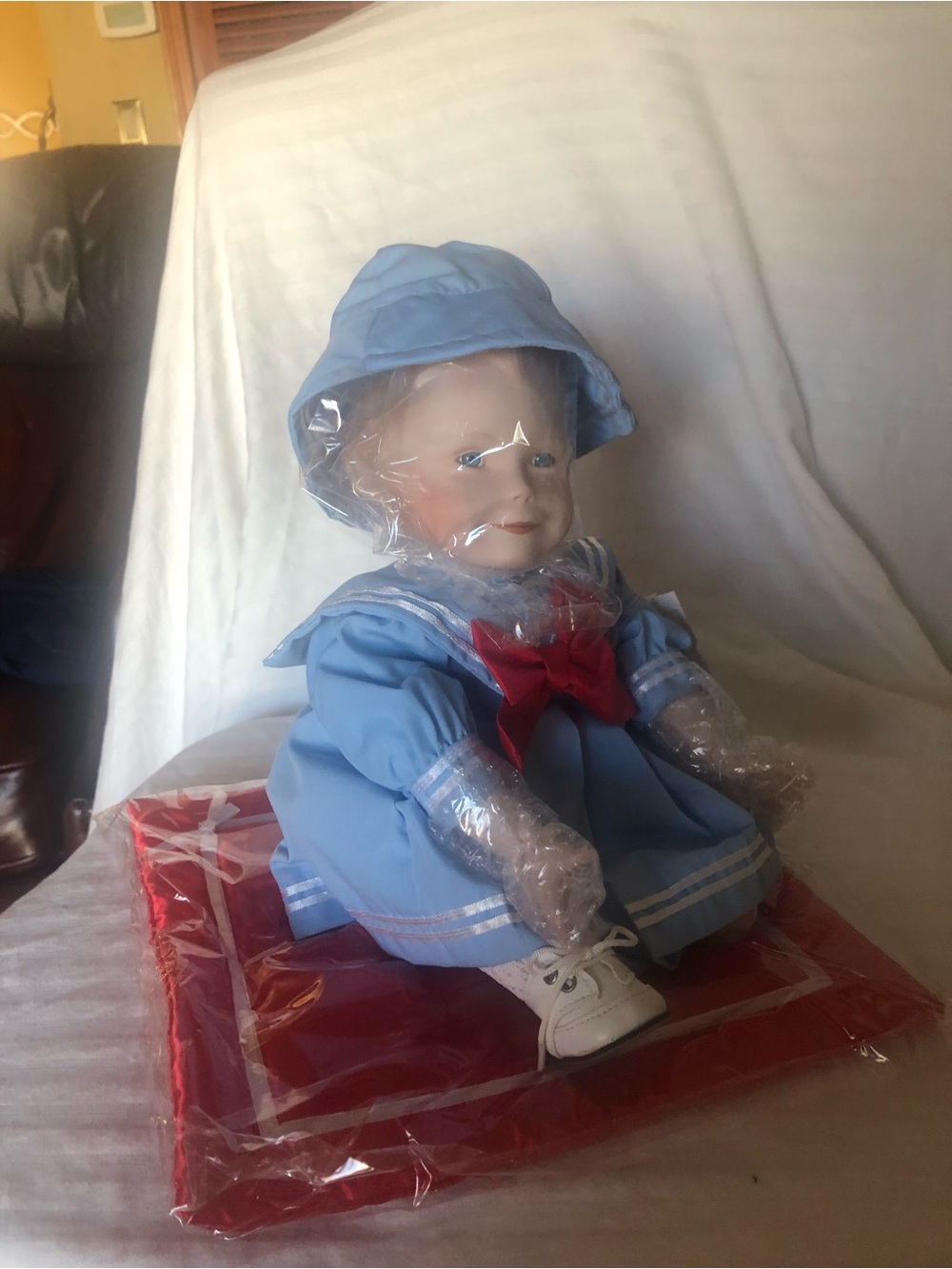 Blue Sailor-Style Baby Doll with Red Bow Accent